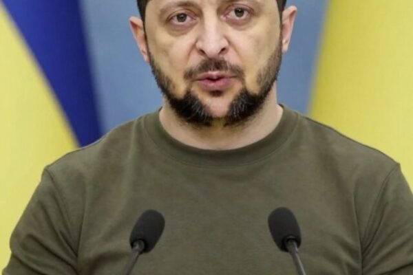 President Volodymyr Zelensky speaking firmly at a press briefing.